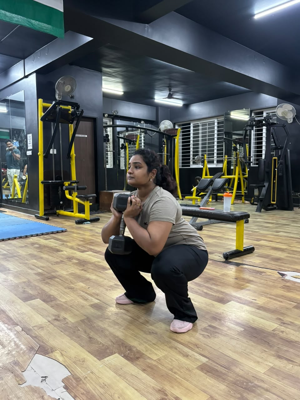 An IMFIT member practising a goblet squat on the third-floor strength area